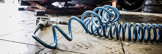 coiled air hose in use with air tool